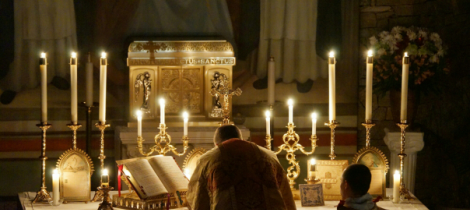 A Priest Offering Mass in Candlelight 