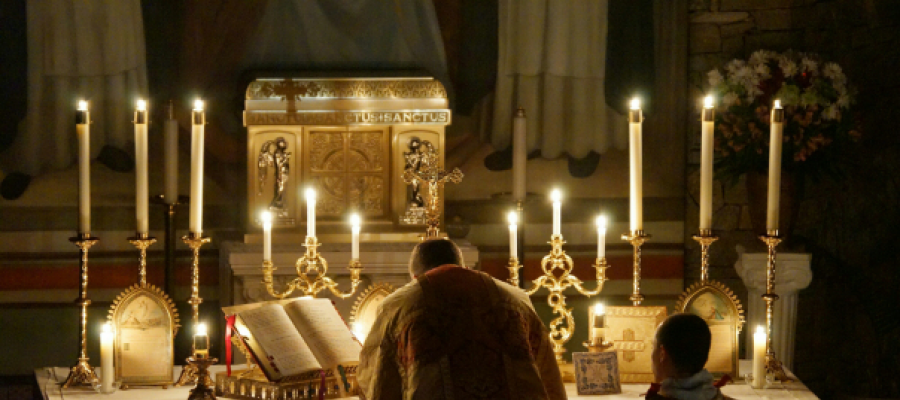 A Priest Offering Mass in Candlelight